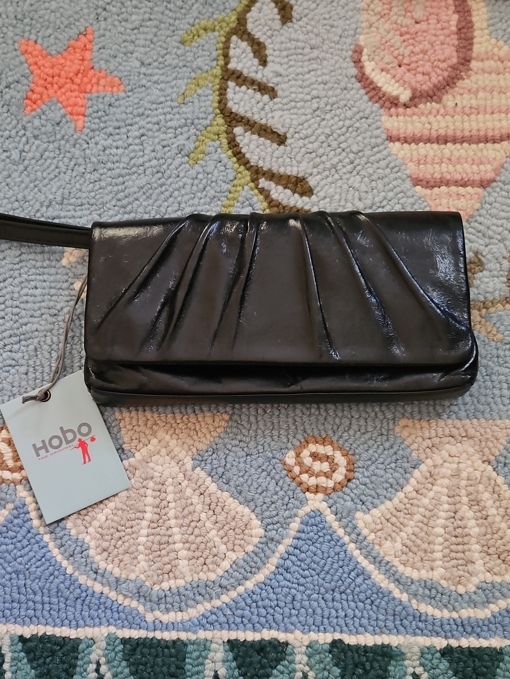 HOBO Black Patent Foldover Clutch with Retractable Wrist Strap